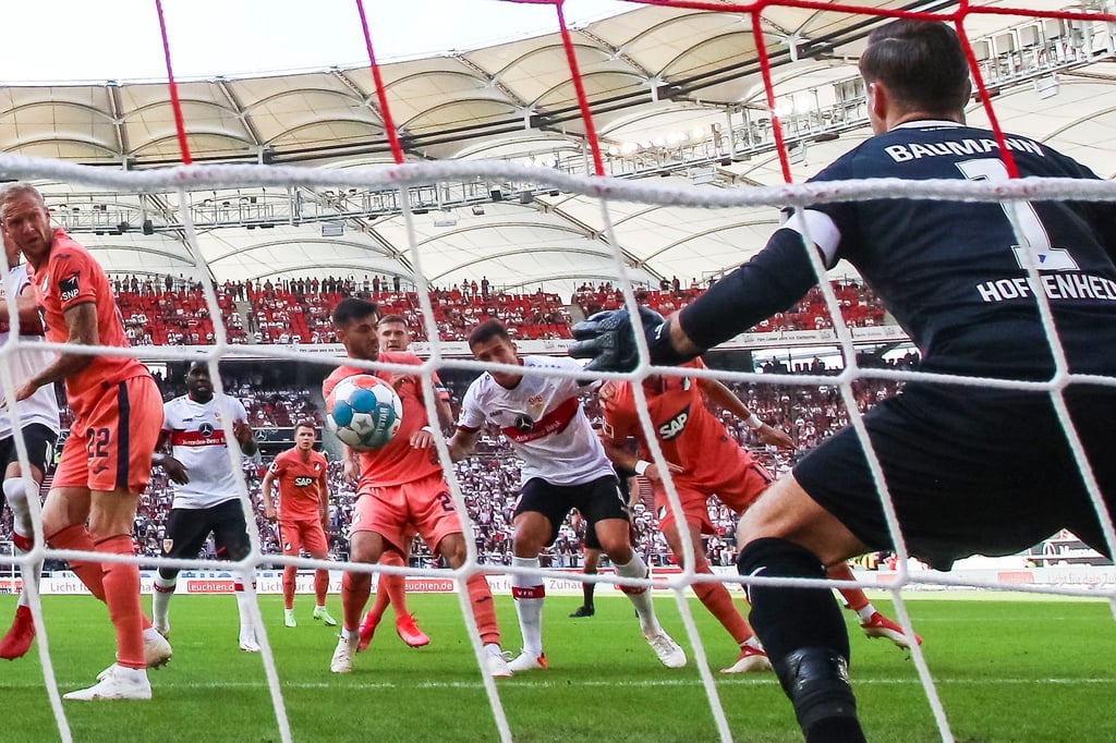Marc Oliver Kempf (M) trifft zum Stuttgarter 1:0 - Hoffenheims Torwart Oliver Baumann (r) bleibt chancenlos.