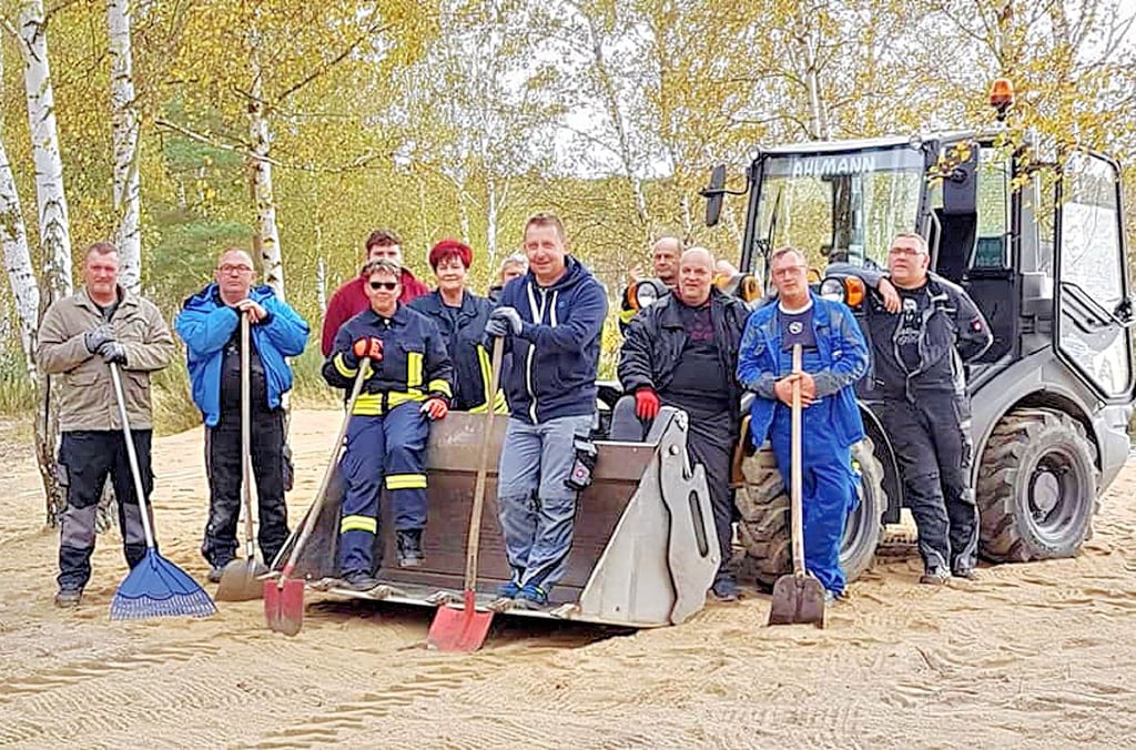 Nach getaner Arbeit: Die Freiwilligen am fertig hergerichteten Strand.