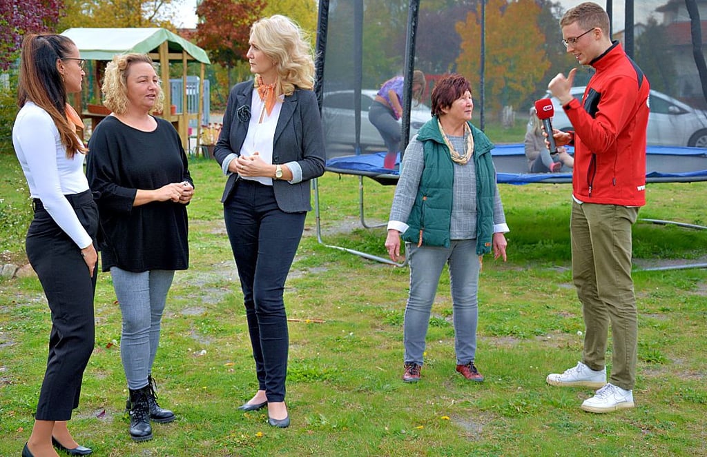 Jennifer Schönfeld (links) und Nicole Thielitz (3. von links) von der Volksbank Gardelegen sind im Gespräch mit Sandy Ritzmann, Standortleiterin der Freizeitoase, während Max Hensch Gewinnerin Ingrid Jankowski interviewt.