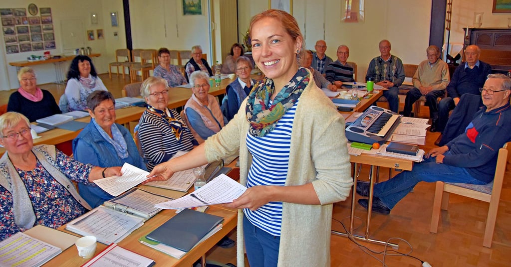 Nach der coronabedingten Pause verteilt Anja Rohlender die Notenblätter an ihre Sangesfreunde. Bei einem Workshop haben die Frauen und Männer unter der Leitung von Reinhard Jerchel ihr Repertoire wieder aufgefrischt.