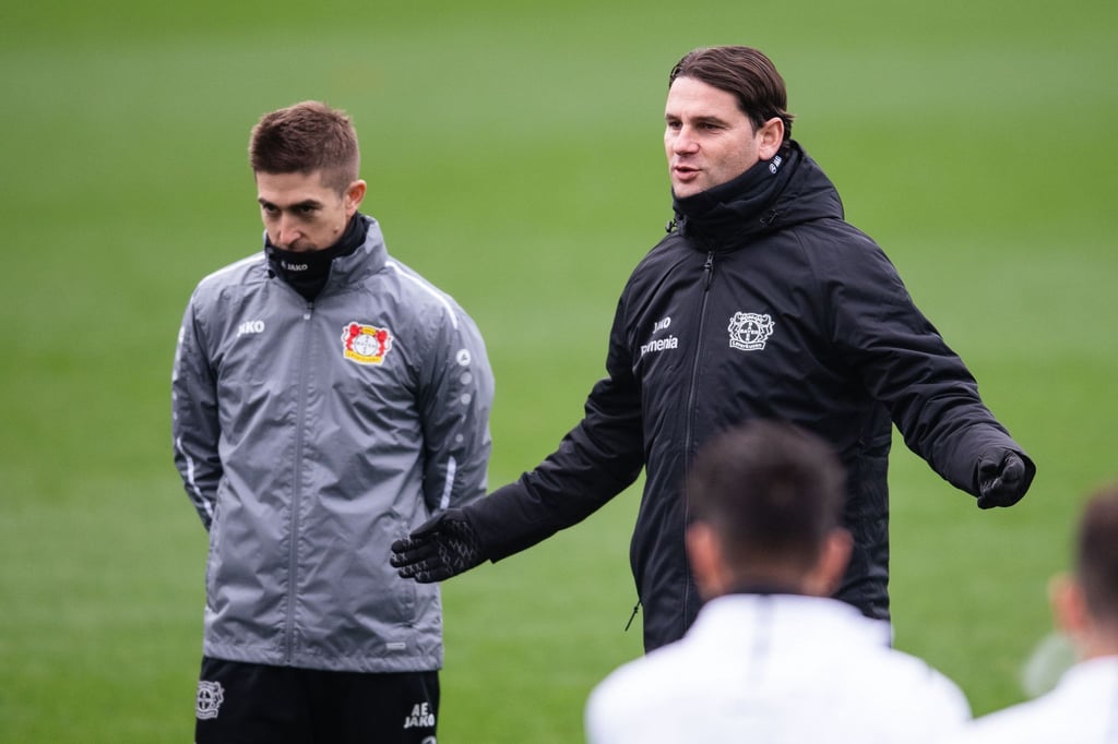 Leverkusens Trainer Gerardo Seoane (r) spricht beim Abschlusstraining zur Mannschaft.