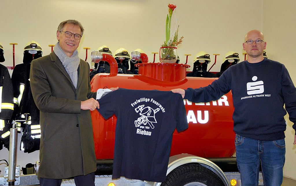 Marktbereichsleiter Fred Schlademann (links) und Ortswehrleiter Frank Rosenberg zeigen die neuen Shirts.