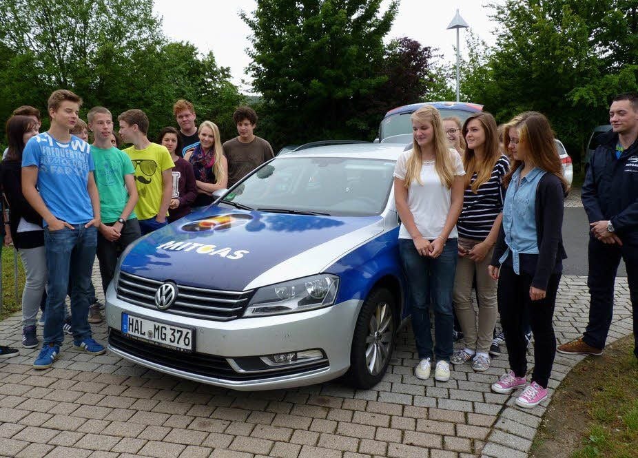 Im Rahmen des Medienprojektes stellte der Mitarbeiter des Projekt-Sponsors Mitgas, Maximilian Kirschner (rechts), den Schülern der 8c des Burgenlandgymnasiums Laucha ein Erdgas-Auto vor.