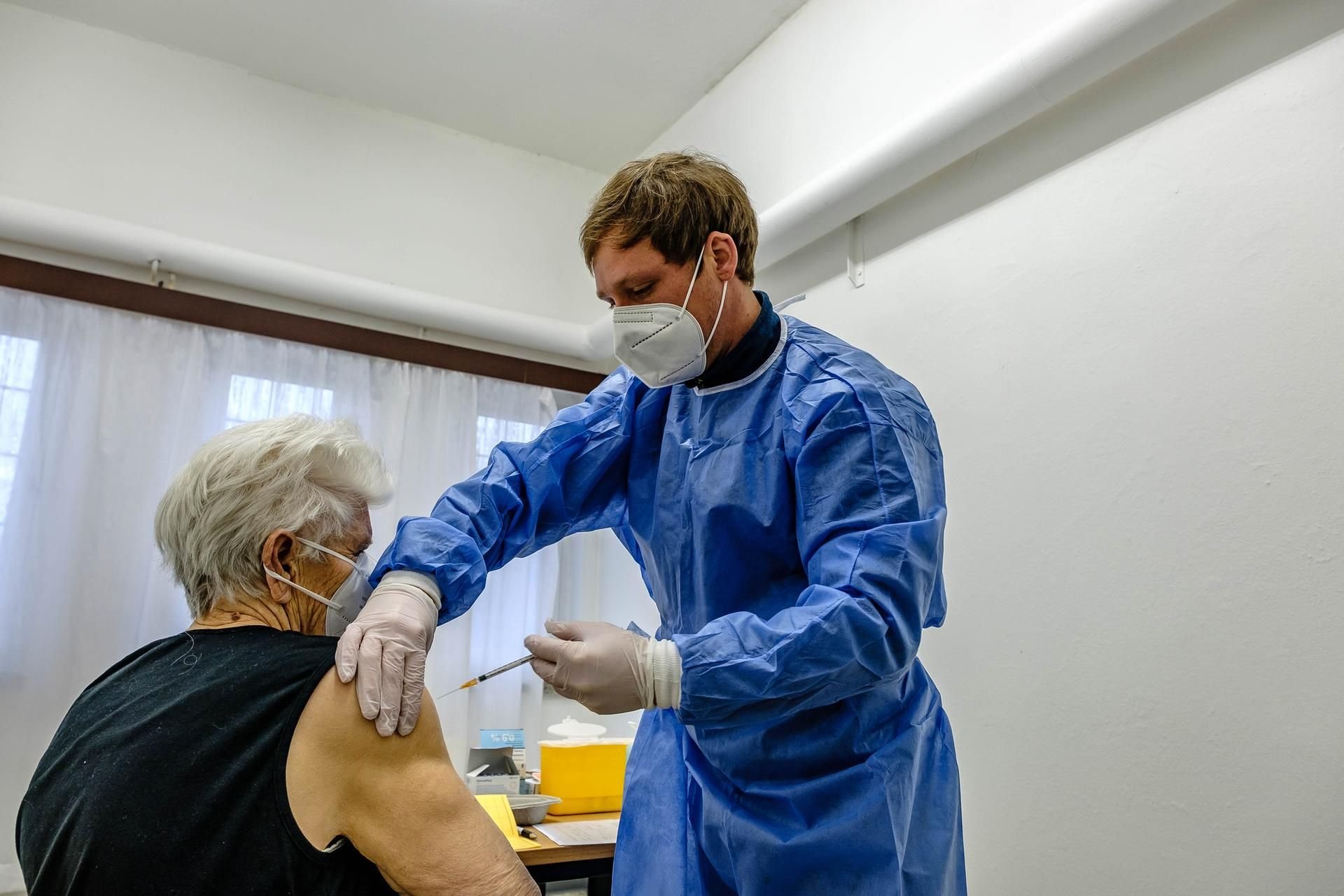 Krankenpfleger Candy Lerm impft Irene Quinque.