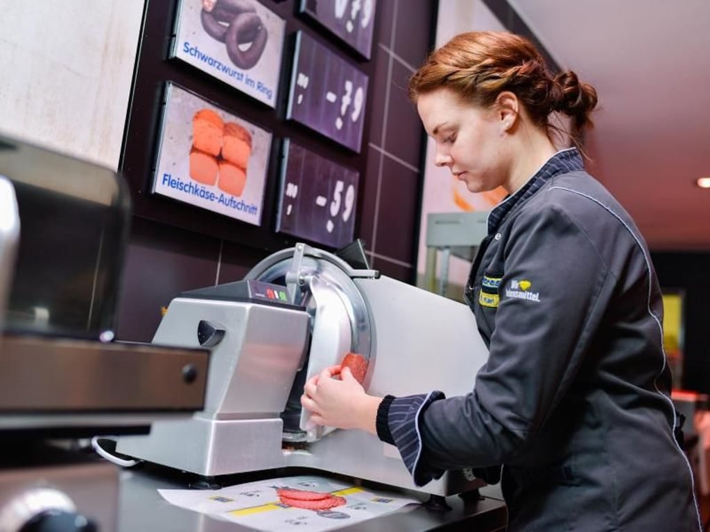 Mit einer scharfen Maschine schneidet Diana Kari Salami für den Verkauf zu. Foto: Uwe Anspach
