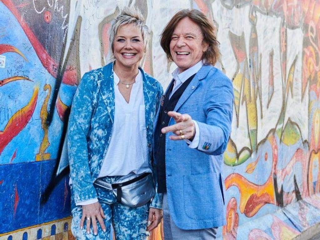 Inka Bause und Jürgen Drews stehen an der East Side Gallery. Foto: Annette Riedl