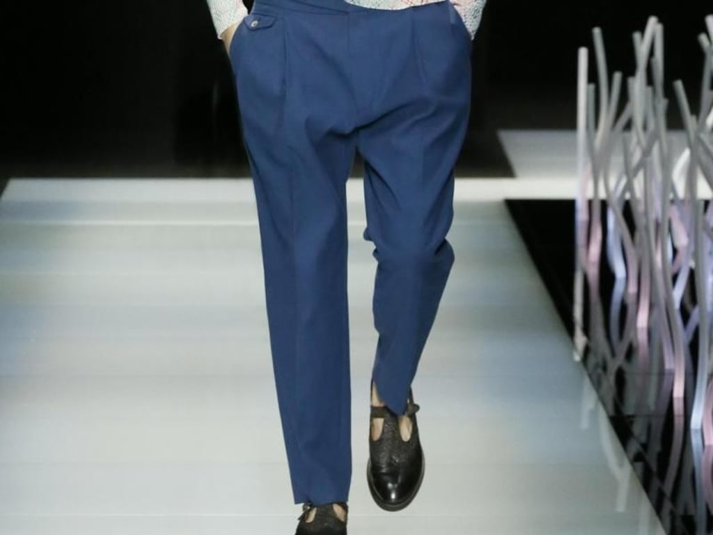 Auch Giorgio Armani zeigt Bundfaltenhosen, die lockerer geschnitten sind und folgt damit dem Trend zur Weite (Pullover 1050 Euro, Hose 450 Euro, Schal 300 Euro). Foto: Giorgio Armani