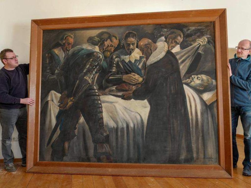 Der Restaurator Mirko Negwer (l) hält das von ihm restaurierte Gemälde des Schwedenkönigs Gustav Adolf zusammen mit Mike Sachse. Foto: Peter Endig