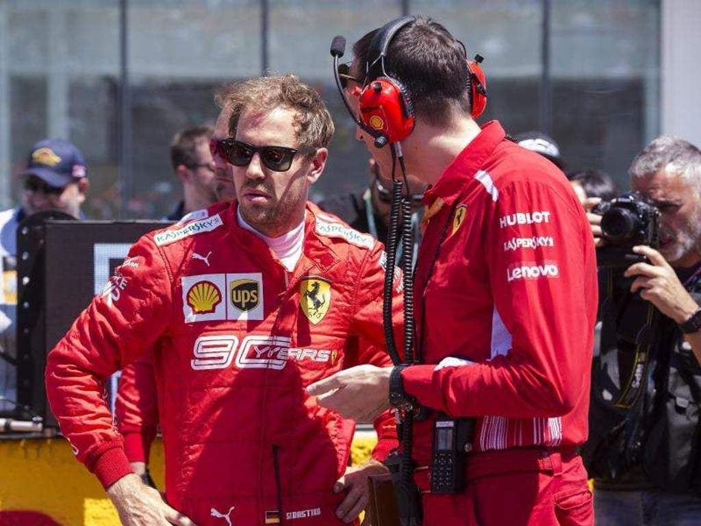 Fachgespräch: Sebastian Vettel (l) mit einem Techniker seines Ferrari-Teams. Foto: Paul Chiasson/The Canadian Press/AP