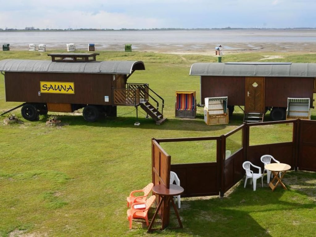 Die Strandsauna in Hooksiel am Jadebusen in Niedersachsen besteht aus einem umgebauten Zirkuswagen - mit Blick aufs Meer. Foto: Wolfgang Nickel/dpa-tmn