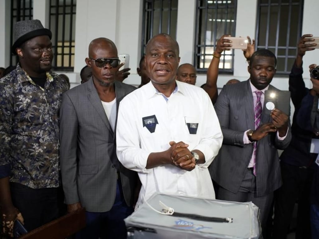 Der Oppositionskandidat Martin Fayulu (M) gibt in Kinshasa seine Stimme ab. Foto: Jerome Delay/AP