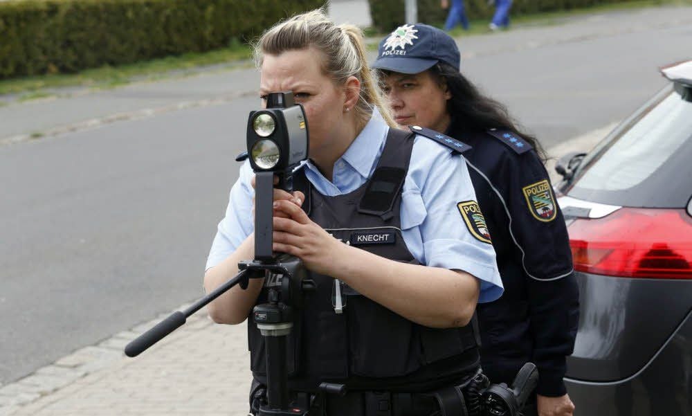 Polizeibeamte blitzen am Vormittag in der Krondorfer Straße in Wolfen, wo Tempo 30 gilt.