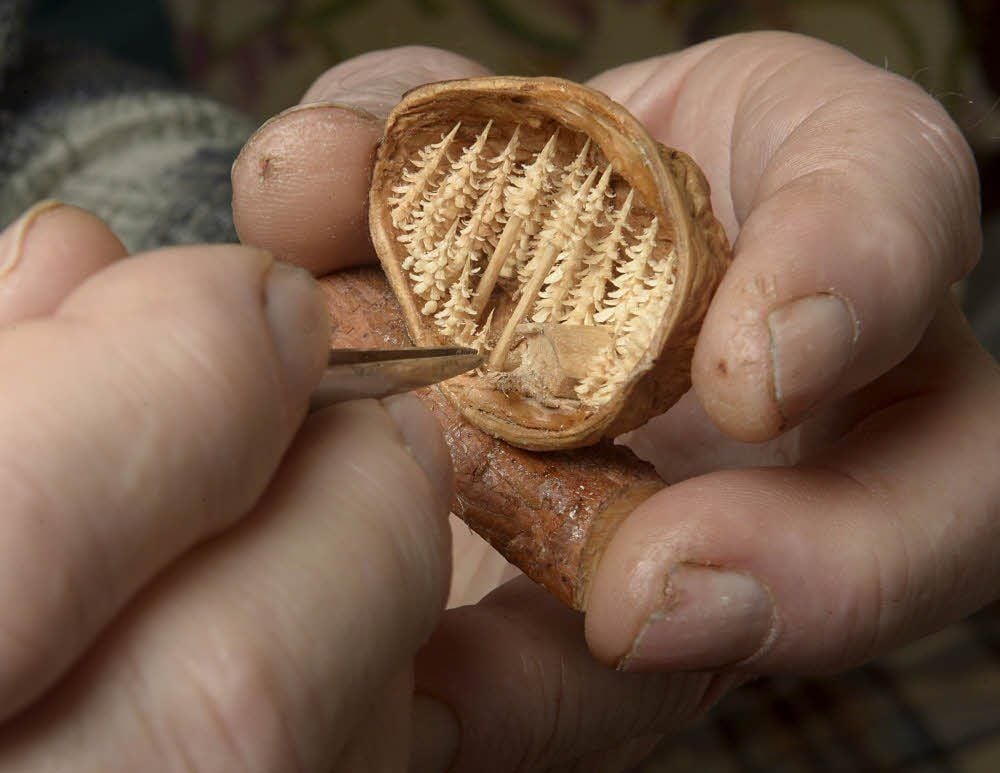 Lothar Lauterbach (oben) ist ein herzlicher Mensch. Seine Liebe gilt der Natur, deren Früchte er für seine Miniaturschnitzereien nutzt. Die Palette seiner Arbeiten reicht von Ohrringen aus Nüssen, Aprikosenkernen oder Kernen einer Palmenart (links) bis zu winzigen Waldlandschaften, die er in Nussschalen unterbringt (rechts).