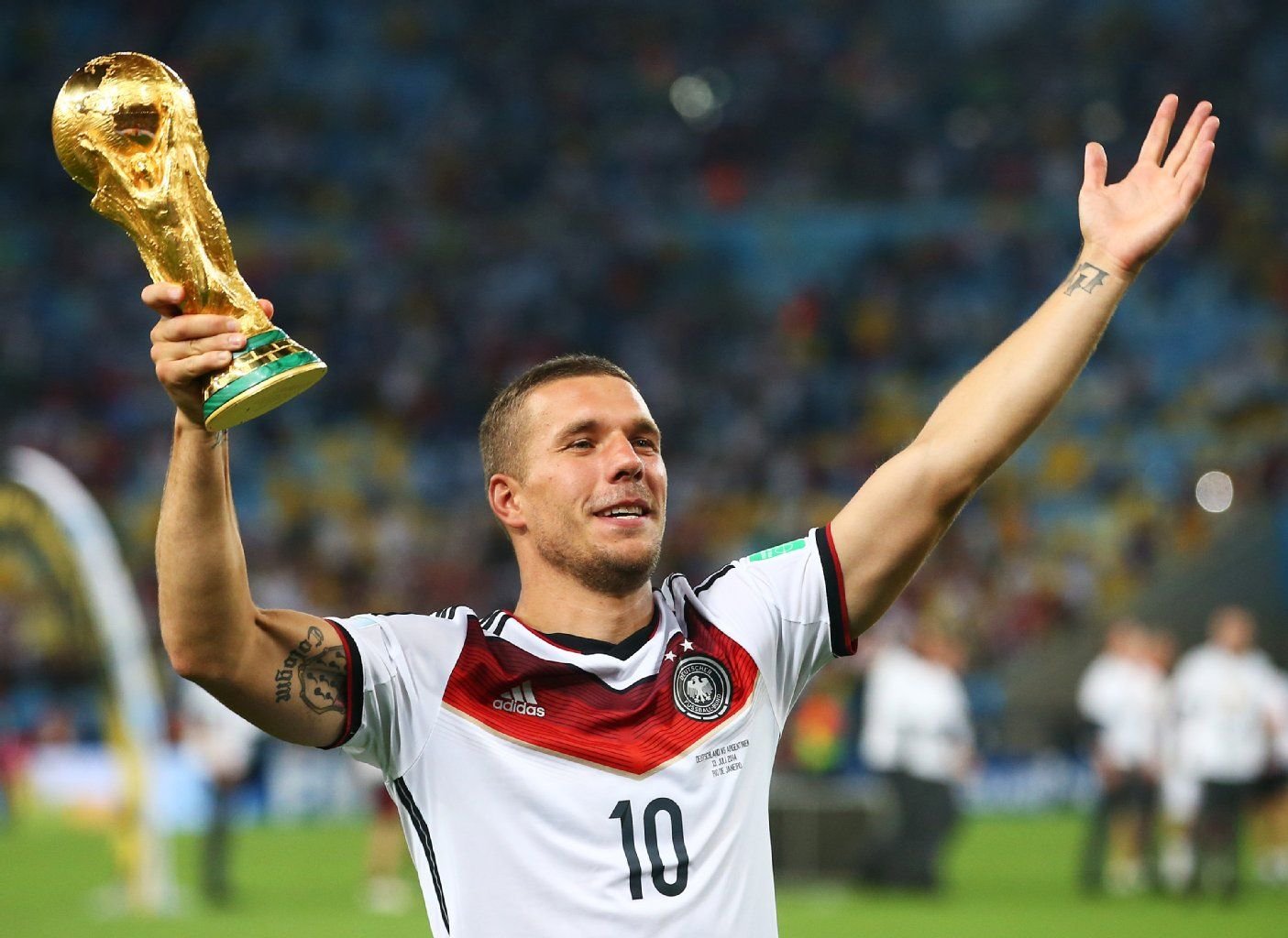 Lukas Podolski präsentiert den WM-Pokal.