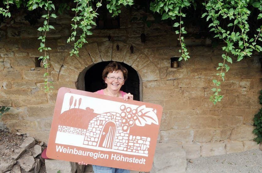 Marion Krüger zeigt das neue Hinweisschild der Winzer.