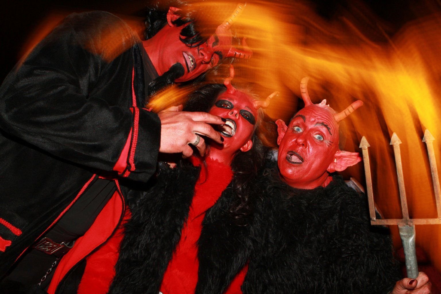 Im Teufelskostüm tanzen in Wernigerode (Sachsen-Anhalt) drei Frauen zur Walpurgisnacht auf dem Wernigeröder Schloss.