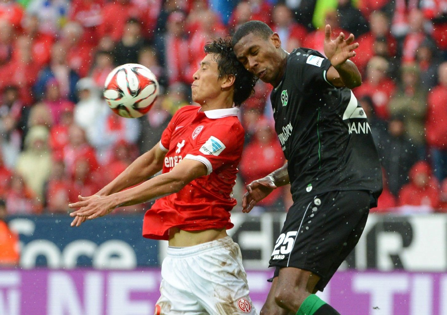 Der Mainzer Ja-Cheol Koo (l) nimmt vor Hannovers Marcelo den Ball mit der Brust an.