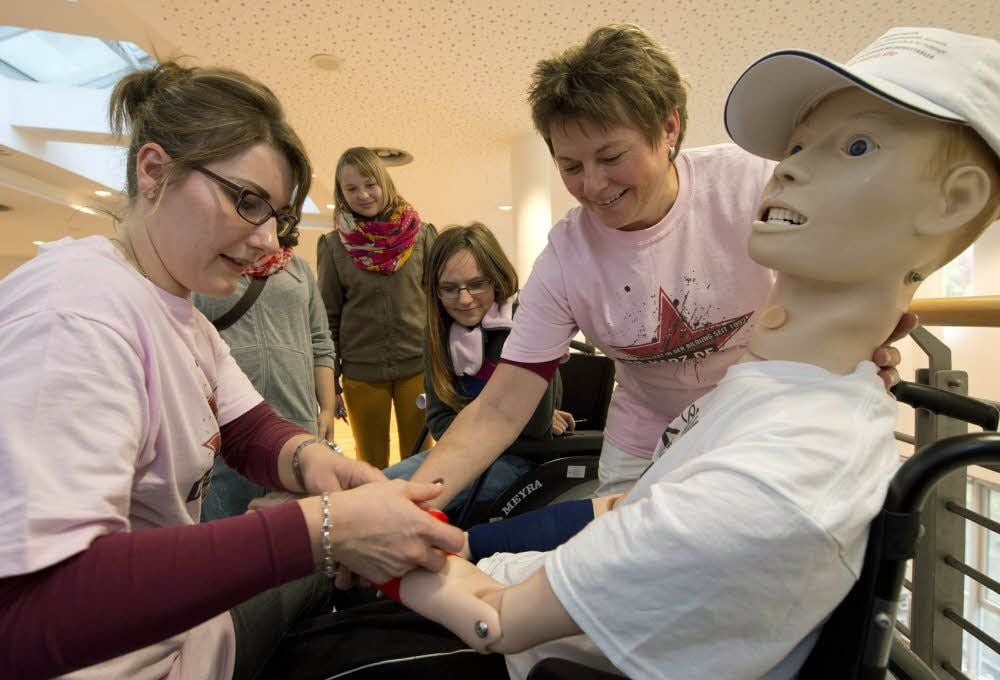 Annika Pospisil und Bianka Losse-Geuer (r.) vertraten das IBB Quedlinburg und zeigen an einem „Patienten“, wie ein Verband angelegt wird.