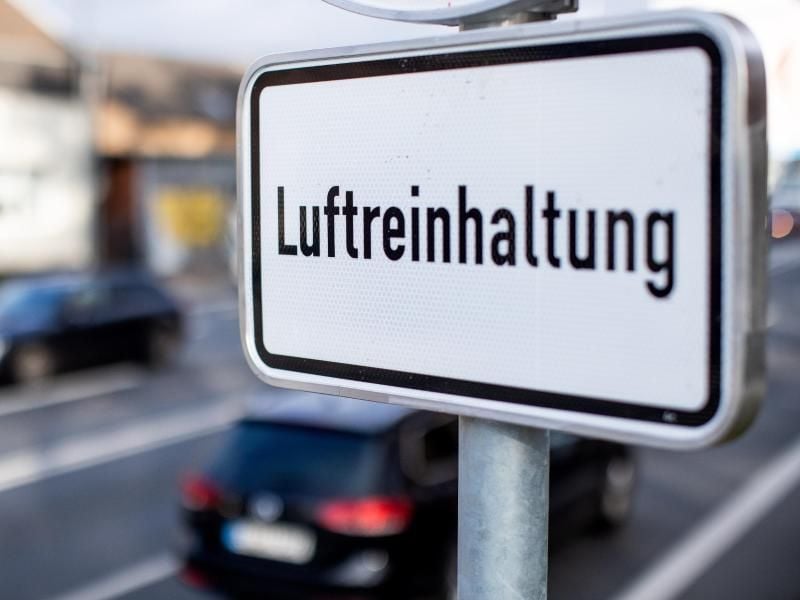 Autos fahren an einem Schild mit der Aufschrift „Luftreinhaltung” vorbei. Foto: Marcel Kusch/Archiv
