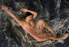 Eine Mitwirkende der argentinischen Show «Fuerzabruta» zeigt in Berlin während einer Fotoprobe in einem Schwimmbecken über den Köpfen der Zuschauer eine artistische Darbietung. (Foto: dpa)