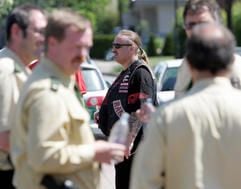 Ein Mitglied der Rockergruppe «Hells Angels» steht am Mittwoch (23.05.2007) vor dem Motorradladen «V-Team» in Ibbenbüren (Kreis Steinfurt) hinter einer Gruppe von Polizeibeamten. (Foto: dpa)