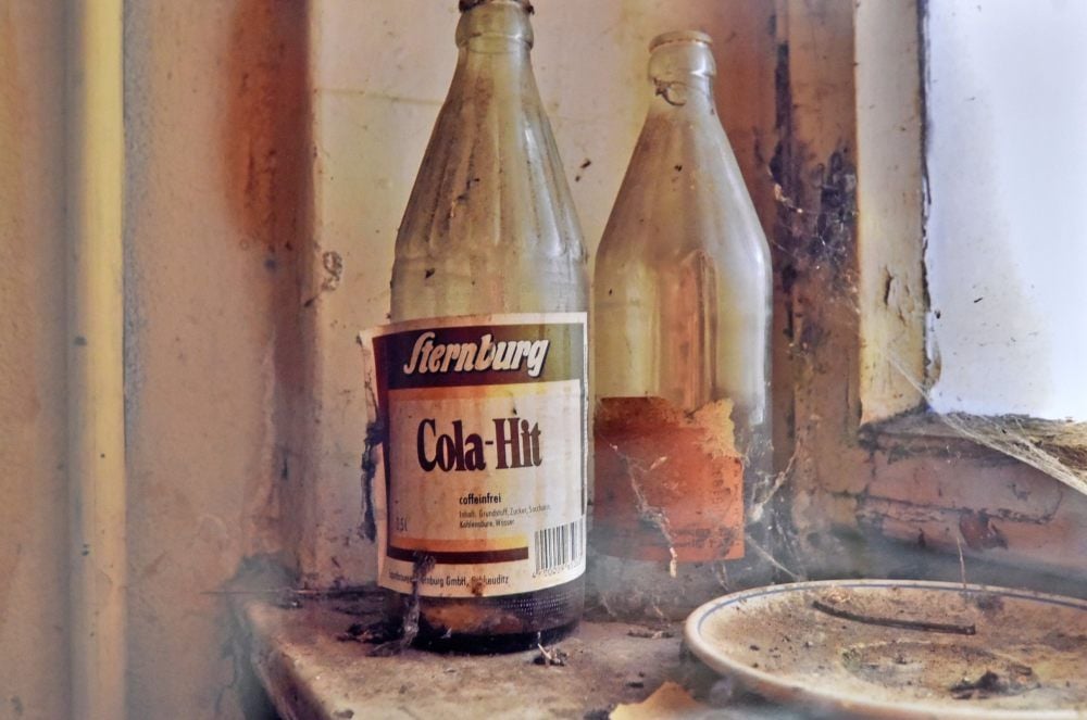 Im früheren Kraftwerk von Zscherndorf verstauben Teller und alte Flaschen. Sie waren einst mit Cola von Sternburg gefüllt.