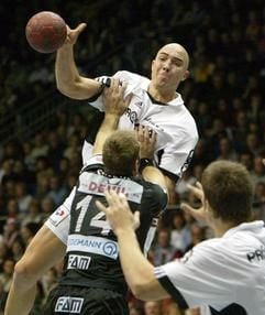 Der Spanier Demetrio Lozano Jarque (M.) vom THW Kiel wird von Steffen Stiebler (SC Magdeburg) am Wurf gehindert (Foto: dpa).