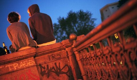 Ein Pärchen sitzt auf dem mit Graffiti beschmierten Geländer der Admiralbrücke im Berliner Stadtteil Kreuzberg. (FOTO: DPA)