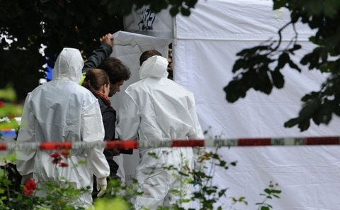 Polizeibeamte und ein Zelt der Spurensicherung stehen am Freitag nach dem Fund einer Frauenleiche in einem Park in Hannover. (FOTO: DPA)