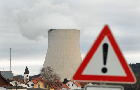Ein Warnschild steht vor dem Kühlturm des Atomkraftwerkes Isar 1 und 2 nahe Essenbach (Niederbayern) (FOTO: DPA/ARCHIV)