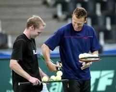 Teamchef Patrik Kühnen (r) gibt bei einem Training in der Karlsruher Europahalle Rainer Schüttler neue Tennisbälle. (Foto: dpa)