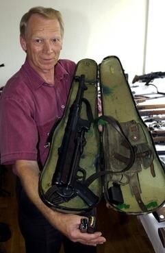 Kriminaloberkommissar Manfred Hartleben zeigt am Dienstag (10.06.2003) auf einer Pressekonferenz in Stendal eine Maschinenpistole im Geigenkasten. (Foto: dpa)