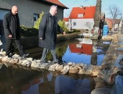 Sachsen-Anhalts Ministerpräsident Wolfgang Böhmer (r./CDU) läuft am Mittwochmorgen (05.04.2006) in Elster bei Wittenberg über ein Sandsackwall. (Foto: dpa)