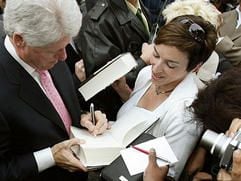 Der ehemalige US-Präsident Bill Clinton signiert mit links einer jungen Frau das Exemplar seines Buches «Mein Leben» in Hamburg. (Foto: dpa)