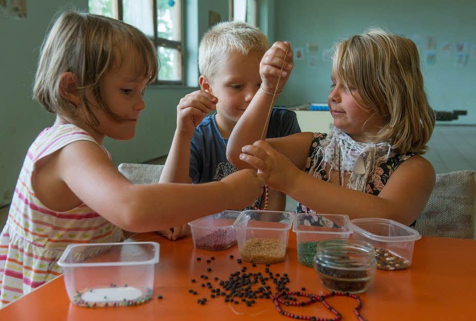 Lisa, Frank und Lena (v.l.) basteln ihren eigenen Indianerschmuck.