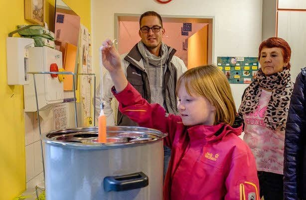 Gute Nachfrage herrschte wie immer nach Adventsgestecken. Rechts: Yasemine durfte die Kerzen dazu ziehen.