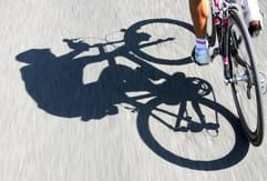 Der Schatten zeigt einen Radsportler fest im Sattel seines Rades. (Foto: dpa)
