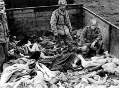 US-Soldaten stehen am 30. April 1945 nach der Befreiung des KZ Dachau auf einem Waggon mit ermordeten Häftlingen. (Foto: dpa)