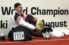 Boris Henry zieht sich nach der Qualifikation im Speerwurf die Schuhe aus. Er konnte sich mit 83,43 Metern für das Finale am Sonntag qualifizieren. (Foto: dpa)