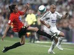 Real Madrids Verteidiger Roberto Carlos (r.) kämpft mit dem Mittelfeldspieler Jonas Gutierrez um den Ball. (Foto: dpa)
