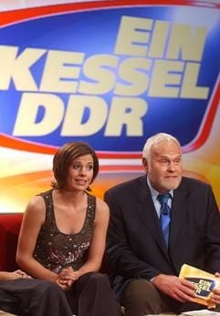 Die beiden Moderatoren Franziska Schenk und Gunther Emmerlich sitzen am 20. August 2003 zur Generalprobe für die neue mdr-Show «Ein Kessel DDR» vor einer Videoleinwand mit dem Logo der Sendung. (Foto: dpa)
