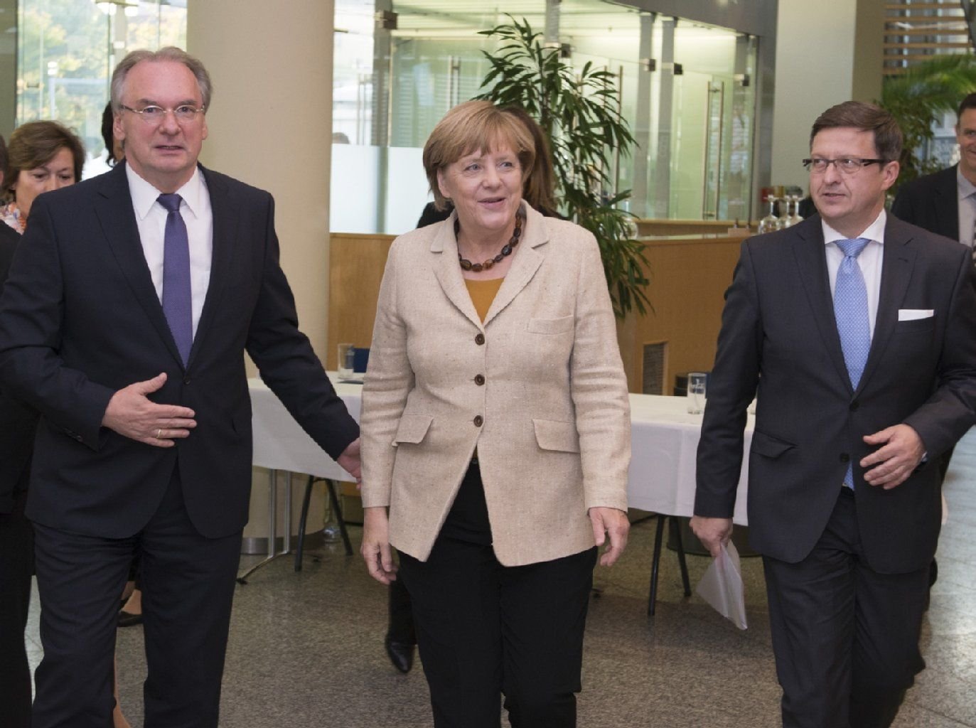 Sachsen-Anhalts Ministerpräsident Reiner Haseloff und Landtagspräsident Detlef Gürth (r.) begrüßen Bundeskanzlerin Angela Merkel in Halle.