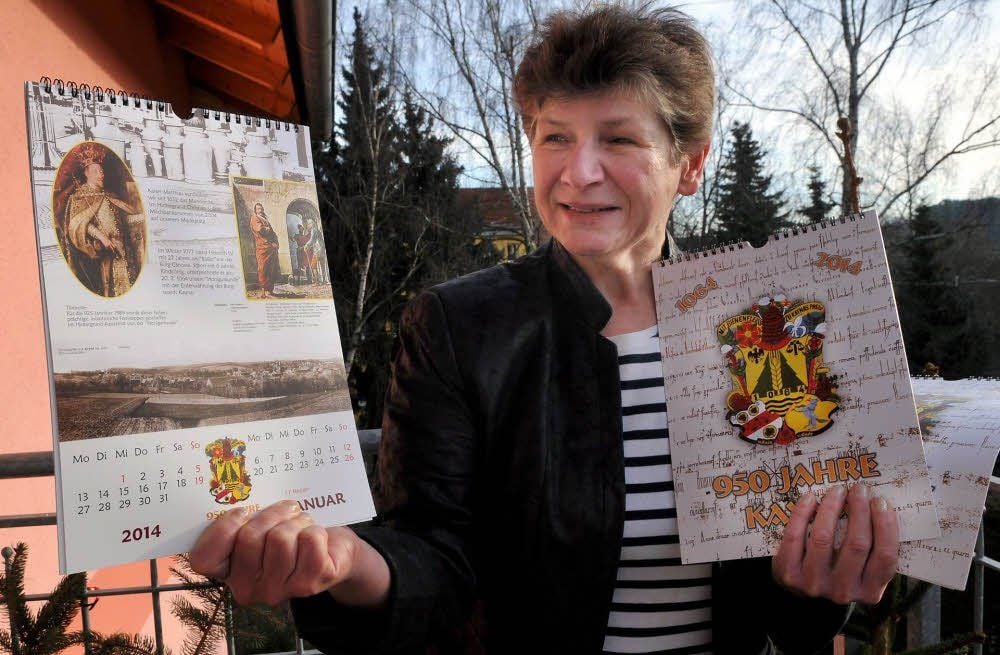 Kerstin Mengel zeigt den Jahreskalender vom Heimatverein Kayna, der sich mit den vielen anstehenden Jubiläen 2014 befasst.