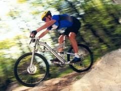Ein Mountainbiker während einer steilen Abfahrt (Foto: dpa)