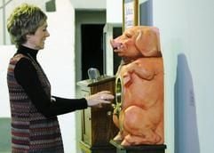 Eine Ausstellungsbesucherin verzieht in Espelkamp in der «Sammlung Gauselmann - Deutsches Automatenmuseum» der Gauselmann AG das Gesicht, nachdem sie einen elektrischen Schlag von dem französischen Münzautomaten «Le Cochon» aus dem Jahr 1908 erhalten hat. (Foto: ddp)