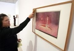 Eine Mitarbeiterin des Max Ernst-Museums reinigt am Donnerstag (07.12.2006) das «Bild aus dem Boudoir» von Paul Klee aus dem Jahr 1922. Gleich mit zwei umfangreiche Ausstellungen präsentieren Museen im Rheinland das Lebenswerk des deutsch-schweizer Künstlers Paul Klee (1879-1940). (Foto: dpa)