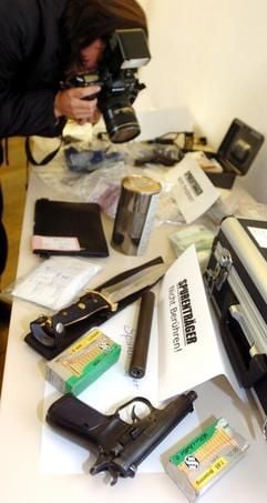 Ein Bildreporter fotografiert am Donnerstag (11.12.2003) auf einer Pressekonferenz in Magdeburg bei einer Großrazzia beschlagnahmte Gegenstände. Bei einer Großrazzia im Rotlichtmilieu haben Ermittler in sieben Bundesländern mehr als 50 Gebäude durchsucht und sieben Verdächtige verhaftet. Die Aktion lief zeitgleich in der Nacht zum Mittwoch (10.12.2003) in Sachsen-Anhalt, Berlin, Brandenburg, Hessen, Niedersachsen, Sachsen und dem Saarland. Schwerpunkt der Razzia war Sachsen-Anhalt. Gegen die Beschuldigten laufen Ermittlungen wegen Bildung einer kriminellen Vereinigung. (Foto: dpa)