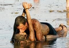 Ein Pärchen küsst sich in einer Schlammpfütze beim polnischen Musikfestival «Haltestelle Woodstock» in Kostrzyn/Küstrin in Polen. Jeder zweite Deutsche würde sich trennen (56 Prozent), wenn der Sex schlecht wäre und der Partner nicht bereit, etwas daran zu ändern. (Foto: dpa)