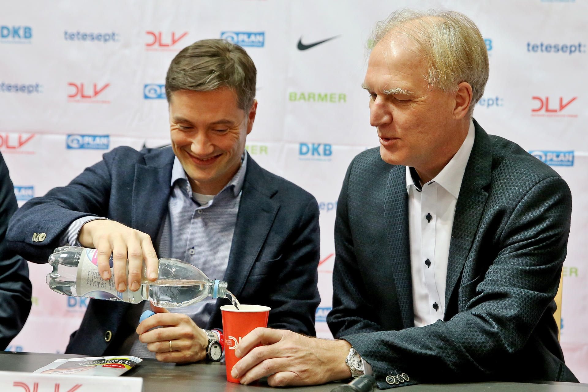 Deutsche Meisterschaften am 18.02.2017 in der Arena Leipzig. Bürgermeister Heiko Rosenthal (l, Die Linke) gießt dem scheidenden Präsidenten des Deutschen Leichtathletik-Verbandes, Clemens Prokop, vor einer Pressekonferenz Wasser ein.