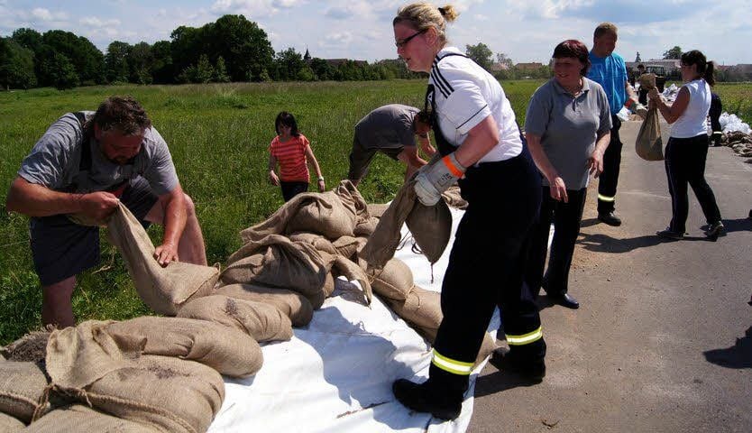 Feuerwehr und Helfer bauen vor Klossa den bereits in den Planungen vorgesehenen Notdeich, nachdem der Damm gebrochen ist.